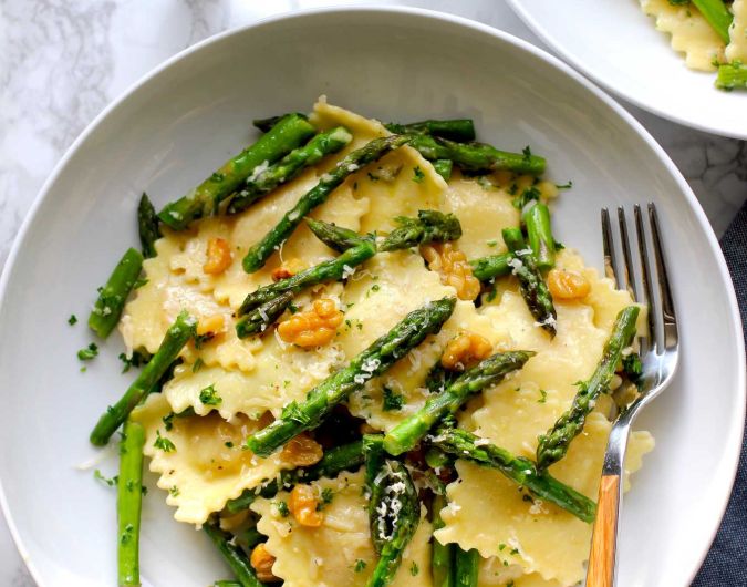 Ravioli with sauteed asparagus and walnuts